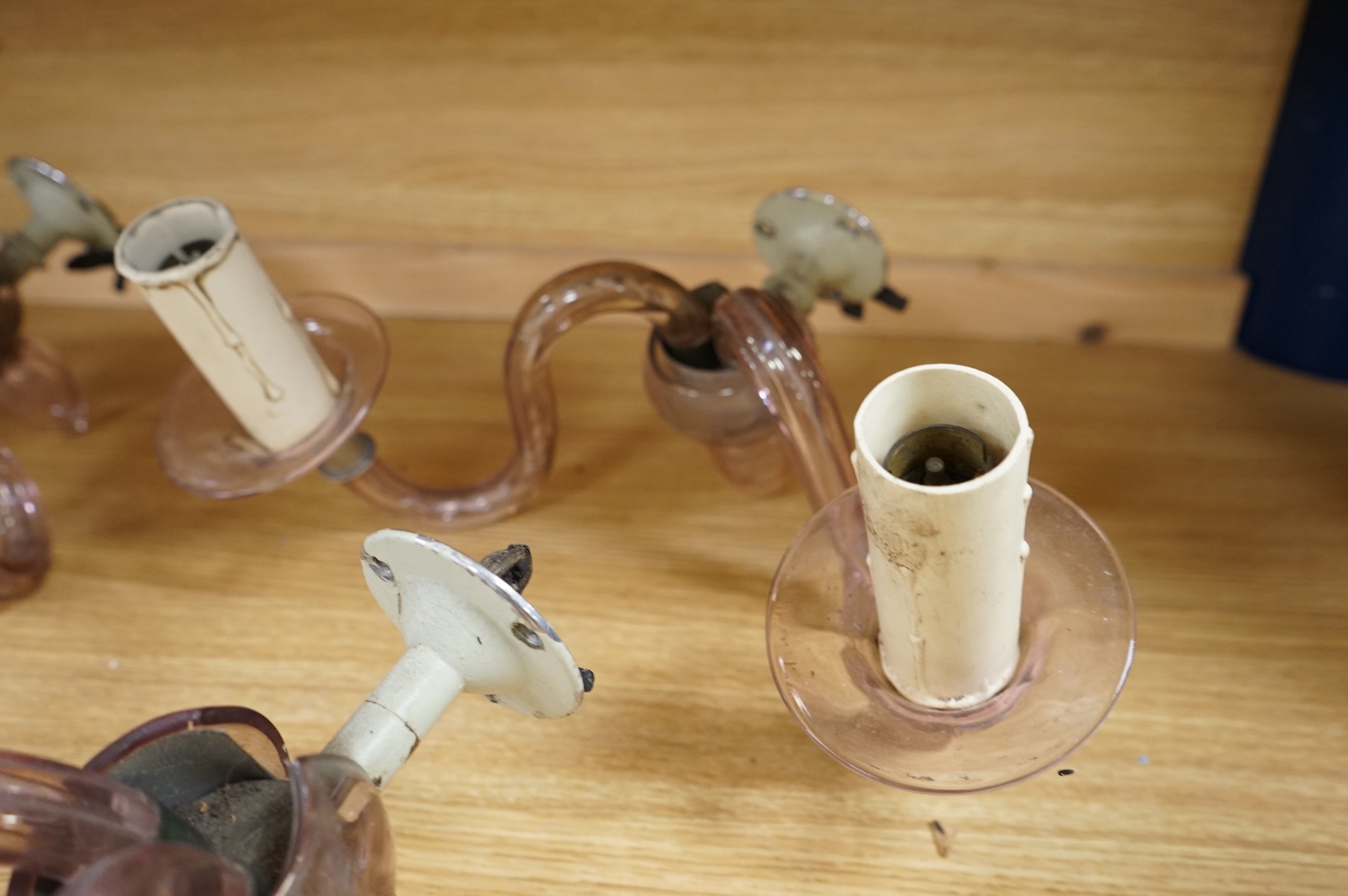 A set of four, two branch, pink glass wall lights, 25cm deep